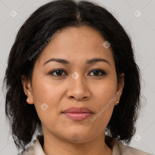 Joyful latino adult female with medium  brown hair and brown eyes