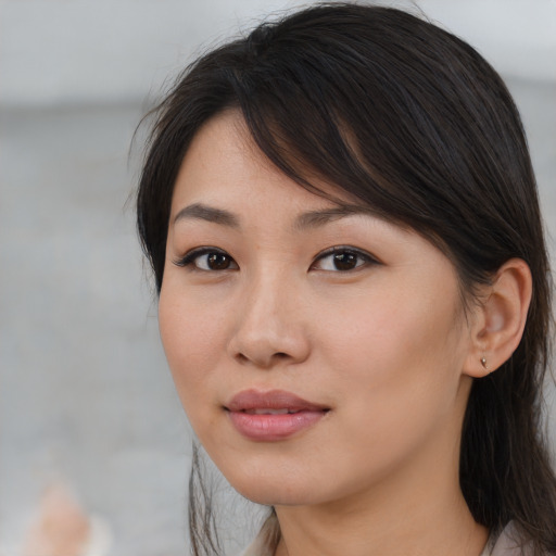 Joyful asian young-adult female with medium  brown hair and brown eyes
