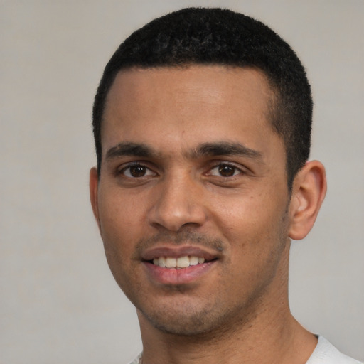 Joyful white young-adult male with short  black hair and brown eyes