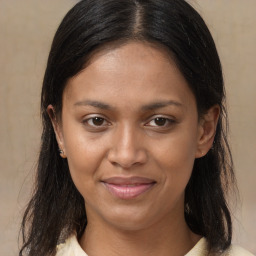 Joyful latino young-adult female with medium  brown hair and brown eyes