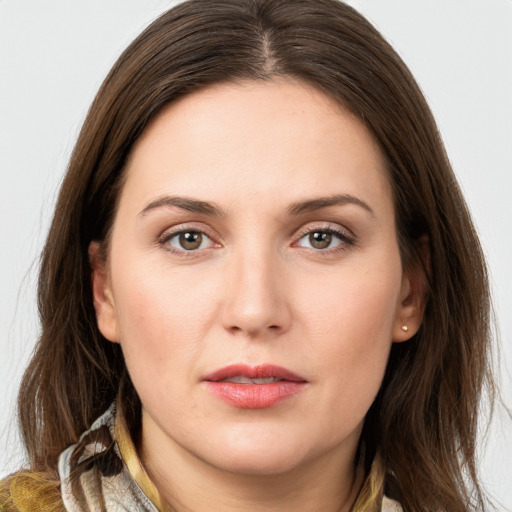 Joyful white young-adult female with long  brown hair and brown eyes