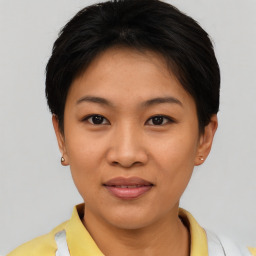 Joyful asian young-adult female with short  brown hair and brown eyes