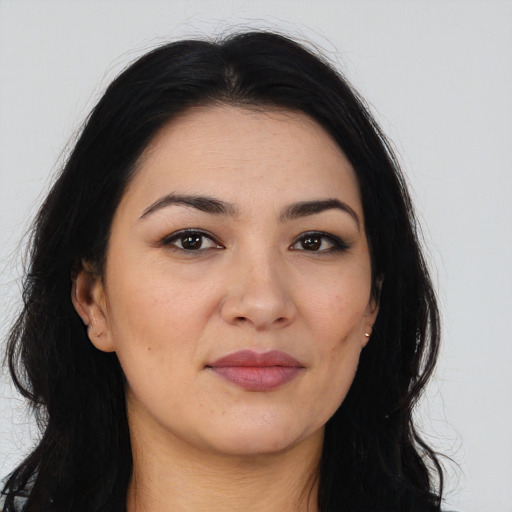 Joyful asian young-adult female with long  brown hair and brown eyes