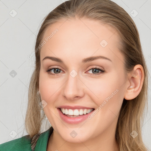 Joyful white young-adult female with long  brown hair and blue eyes