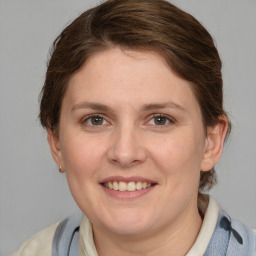 Joyful white adult female with medium  brown hair and grey eyes