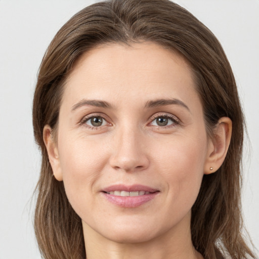 Joyful white young-adult female with long  brown hair and grey eyes