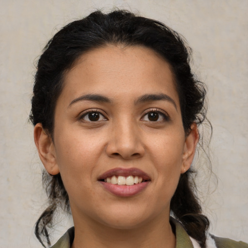 Joyful latino young-adult female with medium  brown hair and brown eyes