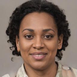 Joyful black adult female with medium  brown hair and brown eyes