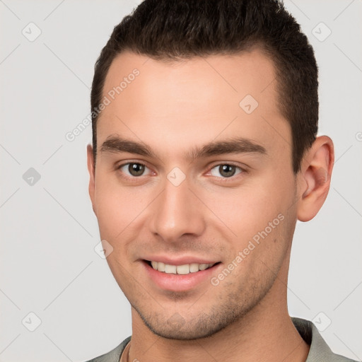 Joyful white young-adult male with short  brown hair and brown eyes