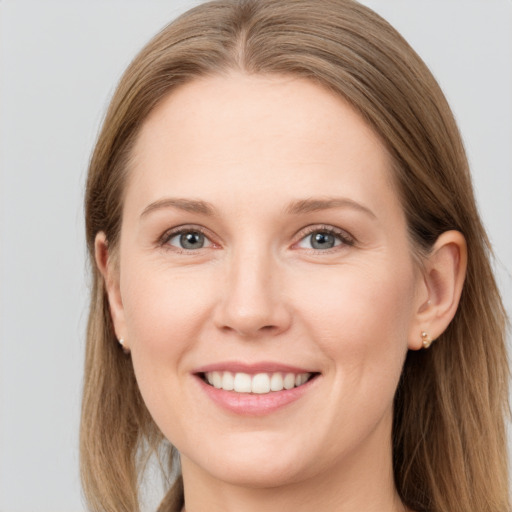 Joyful white young-adult female with long  brown hair and grey eyes