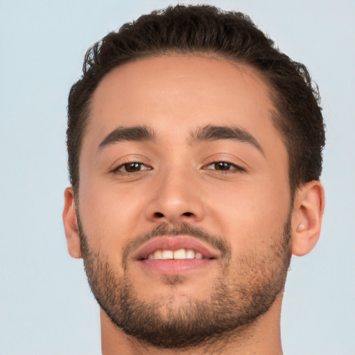 Joyful white young-adult male with short  brown hair and brown eyes