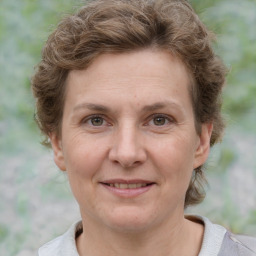 Joyful white adult female with short  brown hair and grey eyes