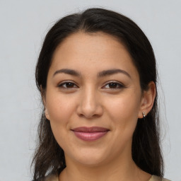 Joyful latino young-adult female with medium  brown hair and brown eyes