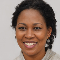 Joyful black adult female with medium  brown hair and brown eyes