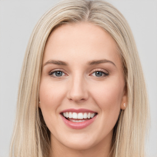 Joyful white young-adult female with long  brown hair and green eyes