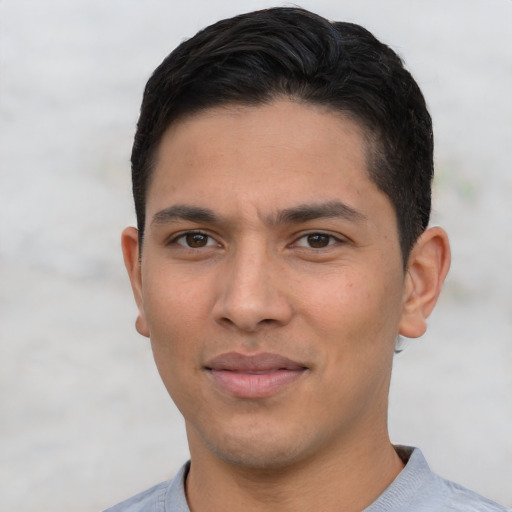 Joyful white young-adult male with short  black hair and brown eyes