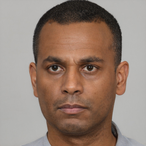 Neutral latino adult male with short  black hair and brown eyes