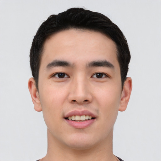 Joyful asian young-adult male with short  black hair and brown eyes