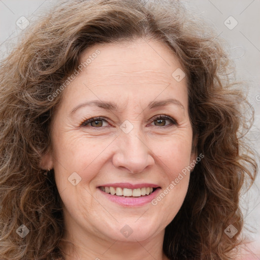 Joyful white adult female with long  brown hair and brown eyes