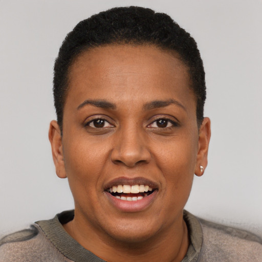 Joyful black young-adult female with short  black hair and brown eyes