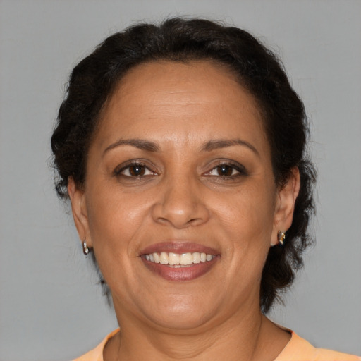 Joyful black adult female with medium  brown hair and brown eyes