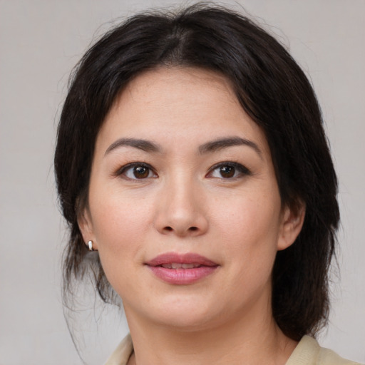 Joyful asian young-adult female with medium  brown hair and brown eyes