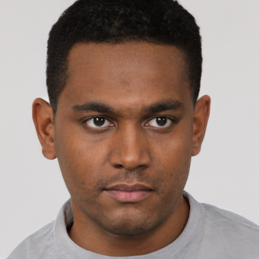 Neutral latino young-adult male with short  brown hair and brown eyes