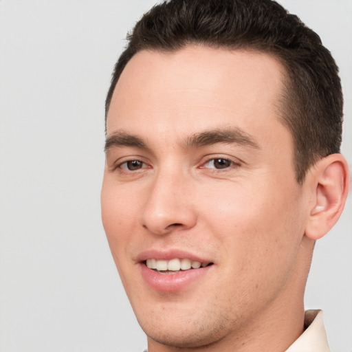 Joyful white young-adult male with short  brown hair and brown eyes