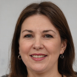 Joyful white adult female with long  brown hair and brown eyes