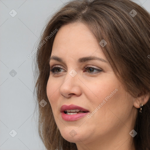 Joyful white adult female with long  brown hair and grey eyes