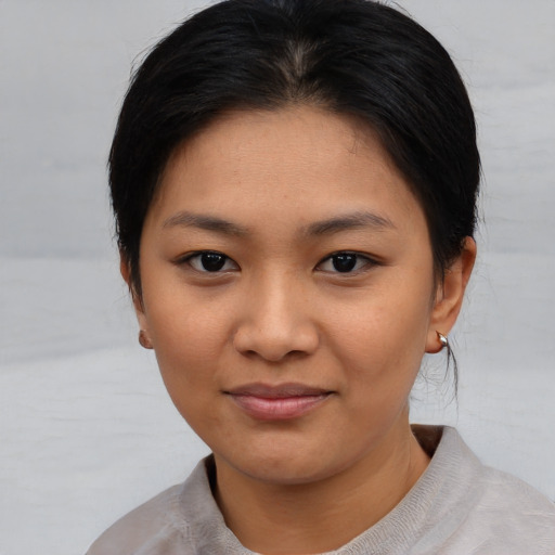 Joyful asian young-adult female with short  brown hair and brown eyes