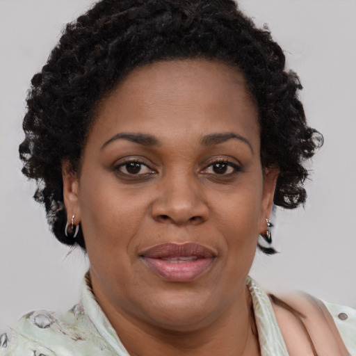 Joyful black adult female with short  brown hair and brown eyes