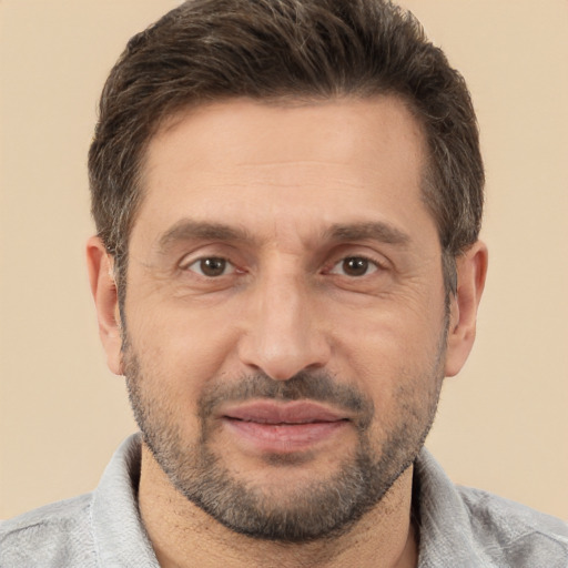 Joyful white adult male with short  brown hair and brown eyes