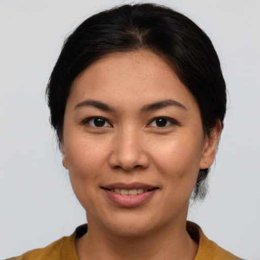Joyful asian young-adult female with medium  brown hair and brown eyes
