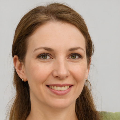 Joyful white young-adult female with long  brown hair and grey eyes