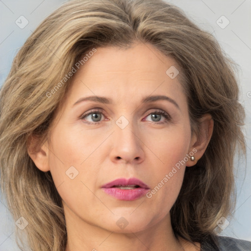 Joyful white adult female with medium  brown hair and grey eyes