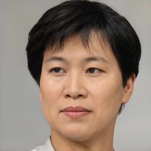 Joyful asian adult female with short  brown hair and brown eyes