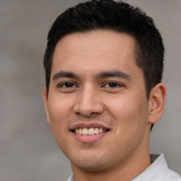 Joyful white young-adult male with short  black hair and brown eyes