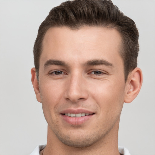 Joyful white young-adult male with short  brown hair and brown eyes