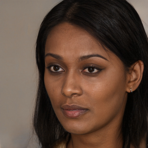 Neutral black young-adult female with long  brown hair and brown eyes