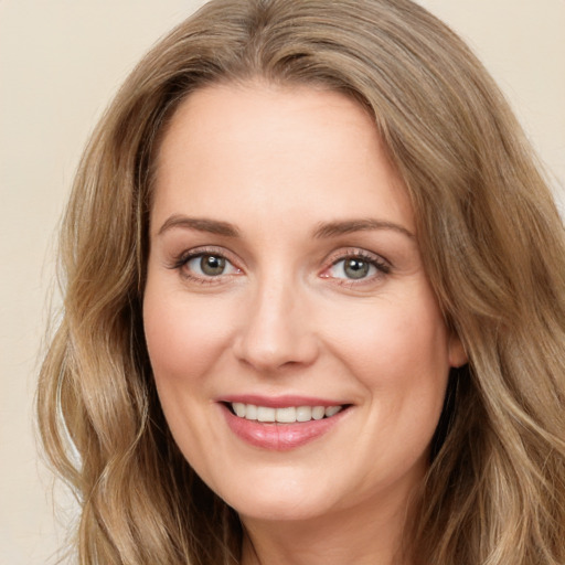 Joyful white young-adult female with long  brown hair and green eyes