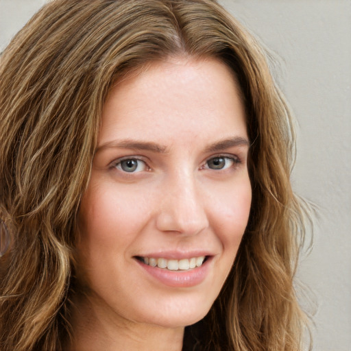 Joyful white young-adult female with long  brown hair and green eyes