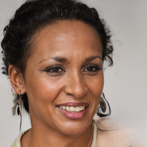Joyful black adult female with medium  brown hair and brown eyes