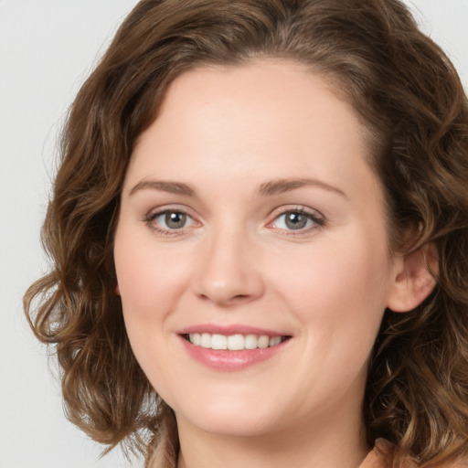 Joyful white young-adult female with long  brown hair and green eyes