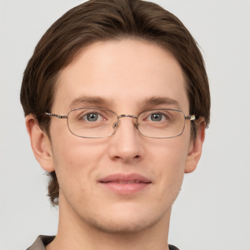 Joyful white adult male with short  brown hair and grey eyes