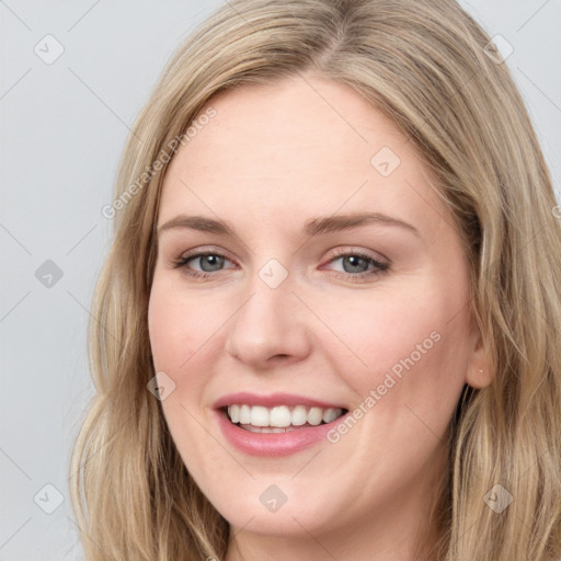 Joyful white young-adult female with long  brown hair and blue eyes