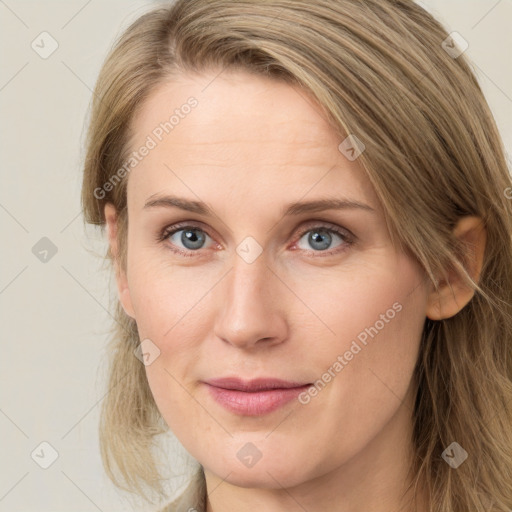 Joyful white young-adult female with long  brown hair and blue eyes