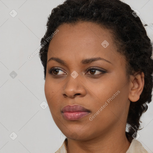 Joyful black young-adult female with medium  brown hair and brown eyes