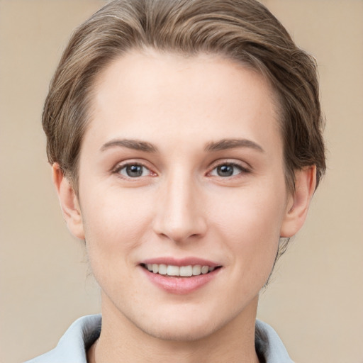 Joyful white young-adult female with short  brown hair and grey eyes