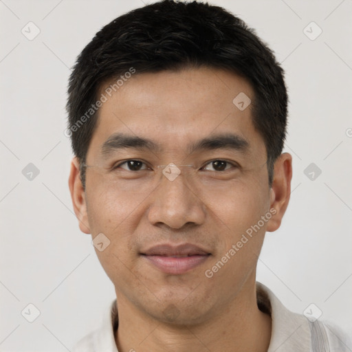 Joyful asian adult male with short  brown hair and brown eyes